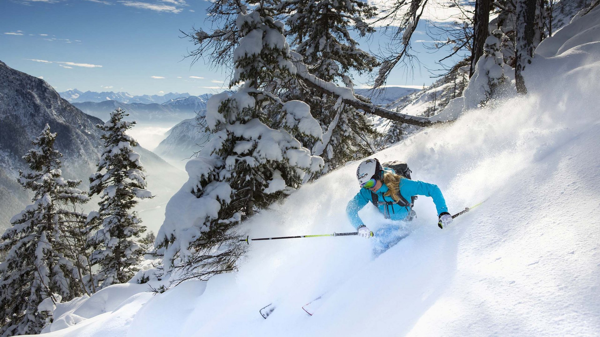 Excursions to the St. Jakob in Defereggental ski resort Skier skiing through fresh powder snow in the mountains