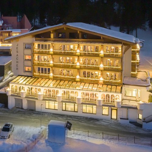 A holiday in St. Jakob in Defereggental Lit Jesacher hotel on snowy winter evening with parked cars